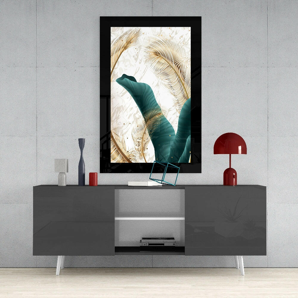 Framed emerald and gold leaf glass art displayed above a gray media console with red decorative accessories in a modern interior setting.
