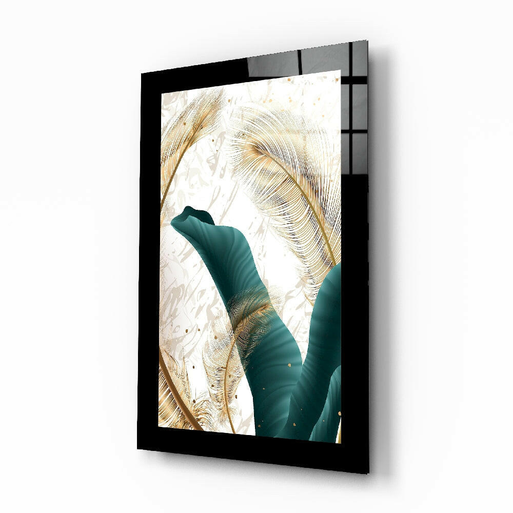 Black-framed glass wall art displaying teal and gold leaf design mounted at an angle against white background.