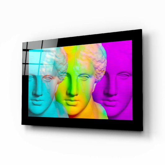Black-framed glass wall art displaying three classical busts in neon cyan, lime-green, and magenta gradient colors against white background.