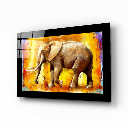 Framed glass wall art displaying a brown elephant against a vibrant orange and yellow abstract background, mounted at an angle.