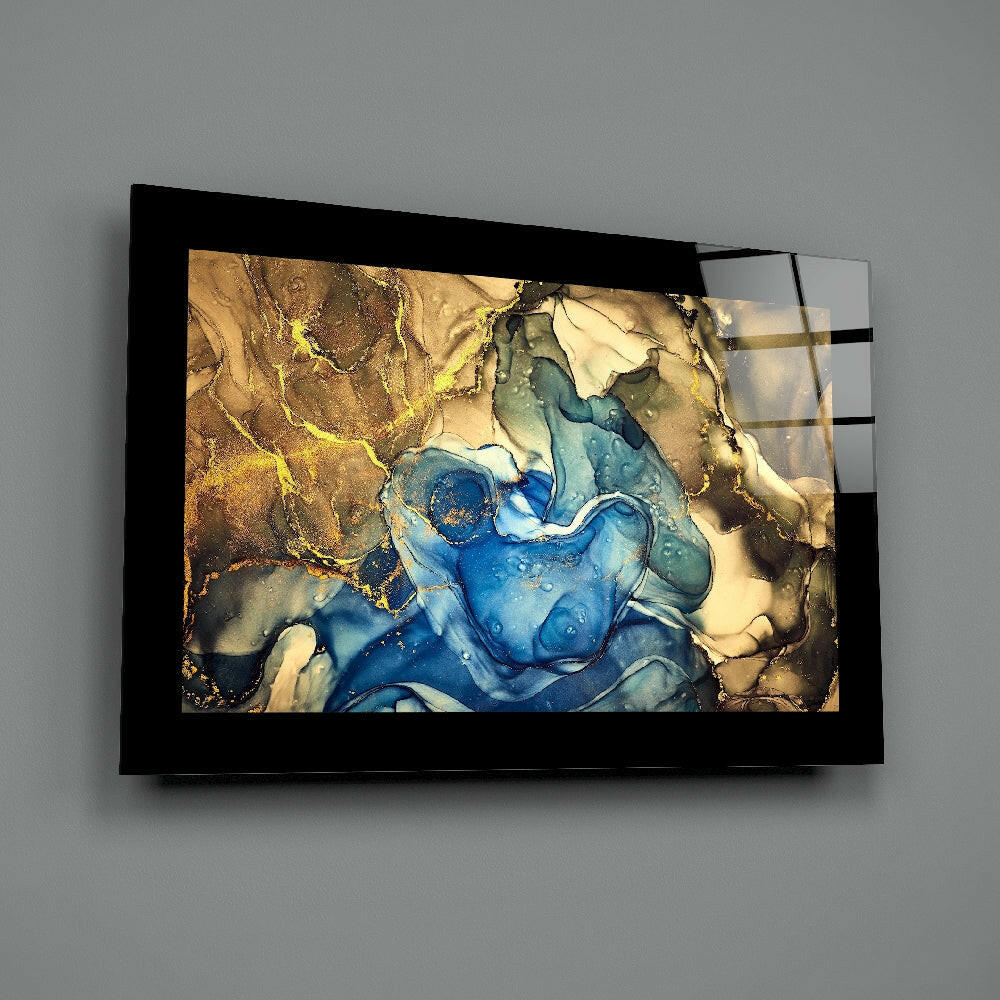 Black-framed glass wall art displaying swirling blue and gold resin design mounted on gray wall.