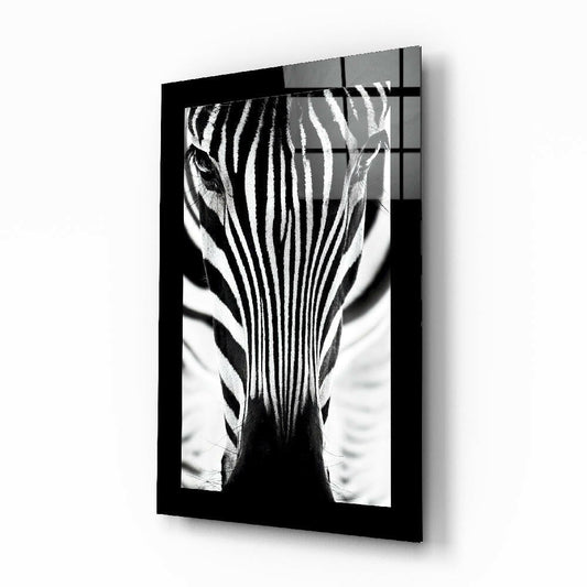 Black-framed glass wall art displaying a backlit black and white zebra head portrait in front view.