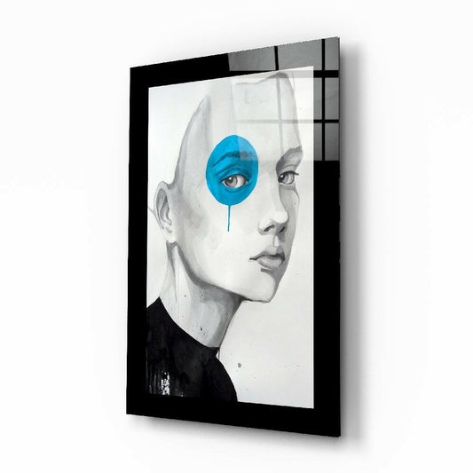 Black-framed glass wall art featuring a pencil-drawn profile of a face with a bright blue circular overlay on the eye.