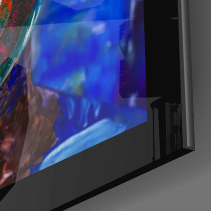 Angled side view of Deep Solitude Glass Wall Art displaying blue and orange abstract imagery on glass panel mounted on black base.