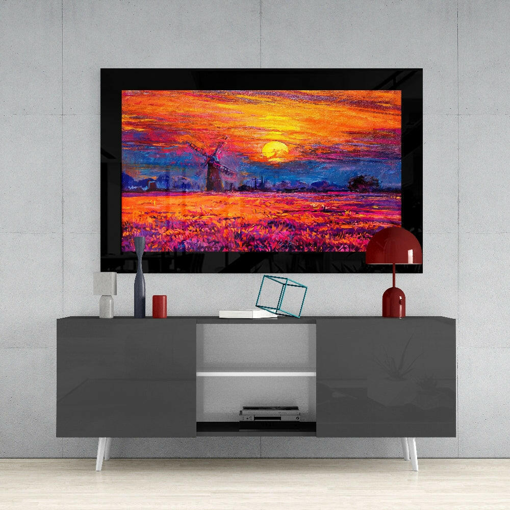 Framed vibrant sunset landscape artwork displayed on gray media console with white legs and red decorative accessories.