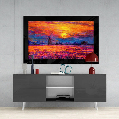 Framed vibrant sunset landscape artwork displayed on gray media console with white legs and red decorative accessories.