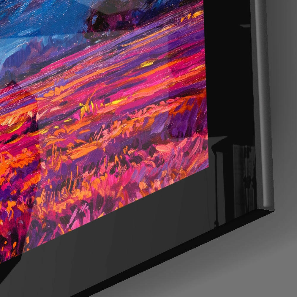 Angled side view of glass wall art displaying vibrant abstract brushstrokes in pink, orange, purple, and yellow hues.
