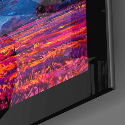 Angled side view of glass wall art displaying vibrant abstract brushstrokes in pink, orange, purple, and yellow hues.