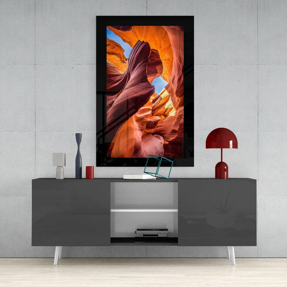 Framed glass wall art of Antelope Canyon's red and orange rock formations displayed above a gray media console in a modern interior setting.