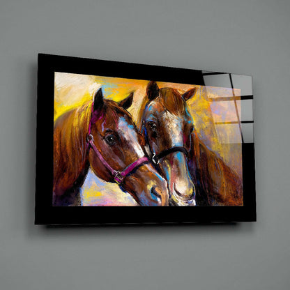 Colorful pastel painting of two horses with vibrant yellow background displayed on black-framed glass wall art mounted on gray wall.