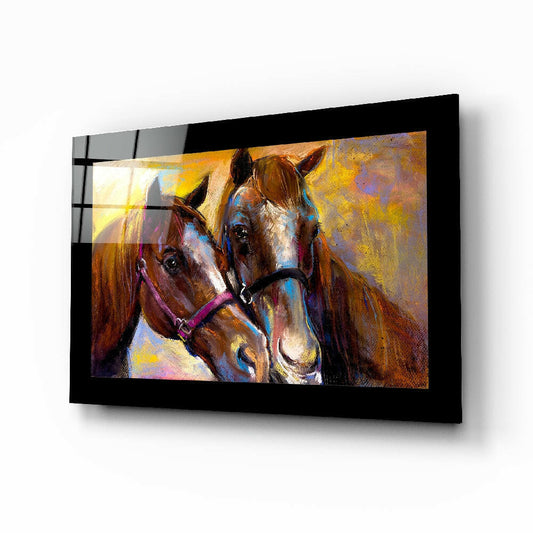 Black-framed glass wall art displaying two colorful horses with purple halters against a golden-yellow textured background, mounted at an angle.