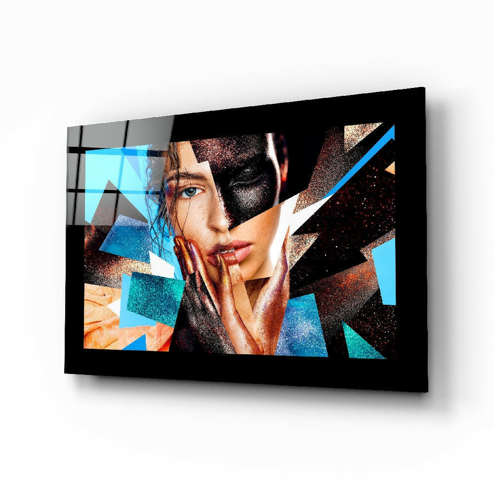 Modern glass wall art displaying geometric abstract design with woman's face, blue and copper triangular shapes on black background, mounted at angle.