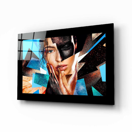 Modern glass wall art displaying geometric abstract design with woman's face, blue and copper triangular shapes on black background, mounted at angle.
