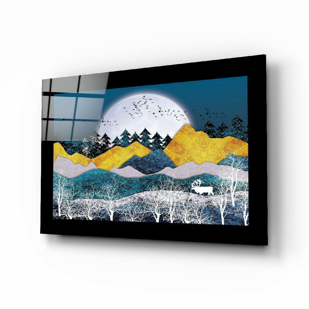 Black-framed glass wall art displaying layered landscape with golden mountains, white moon, white birch trees, and grazing deer against teal and blue tones.
