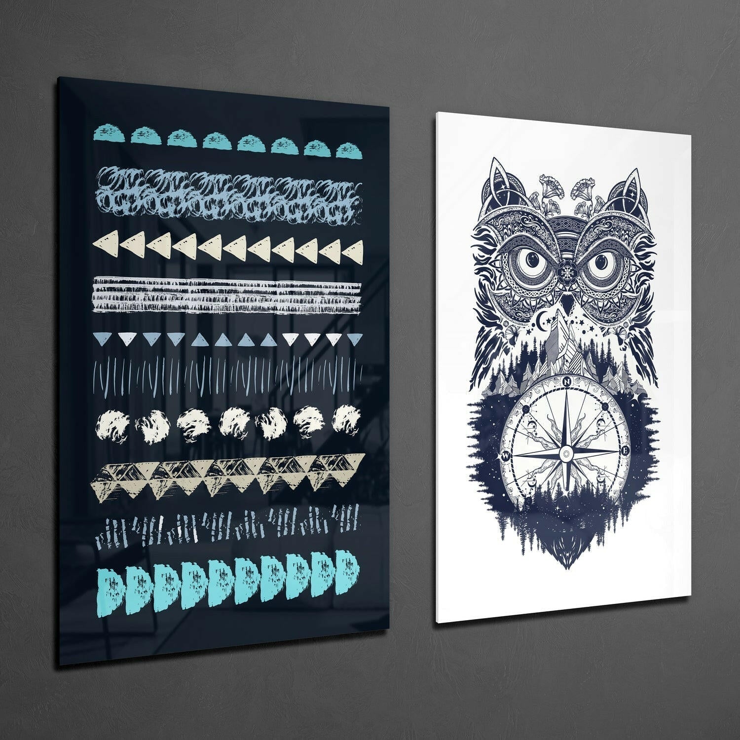 Two glass wall art pieces displayed at an angle: left panel features geometric patterns in turquoise and cream on dark background; right panel shows an ornate owl design with compass rose on white background.