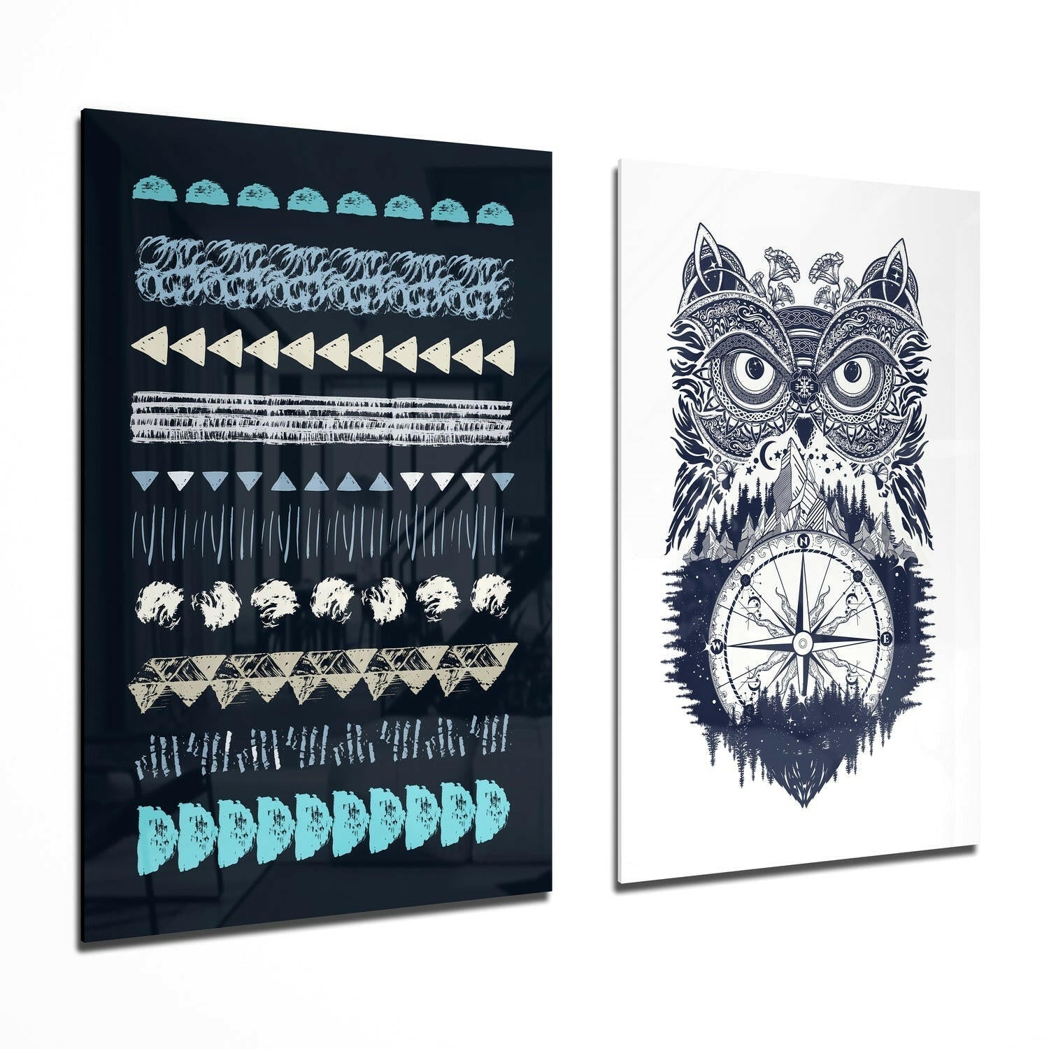 Two glass wall art panels displayed at an angle: left panel with geometric patterns in turquoise, cream, and gray on black; right panel with intricate owl and compass design in navy and white.