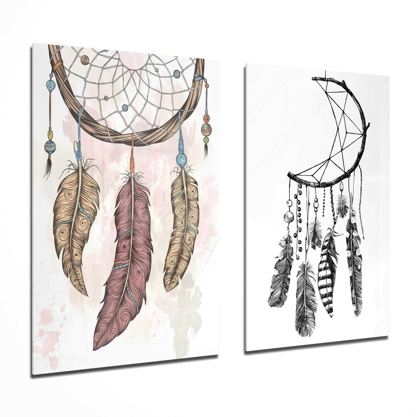 Two glass wall art panels displayed at an angle showing colorful and monochromatic dreamcatcher designs with feathers and beads.