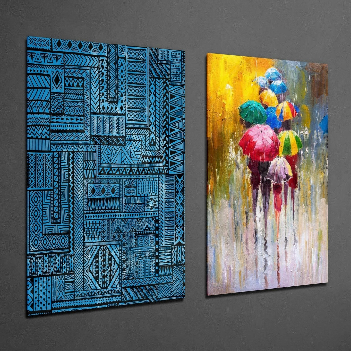 Two glass wall art panels displayed side-by-side: left panel features blue geometric patterns on black background; right panel shows colorful umbrellas in rain with yellow, red, and blue tones.