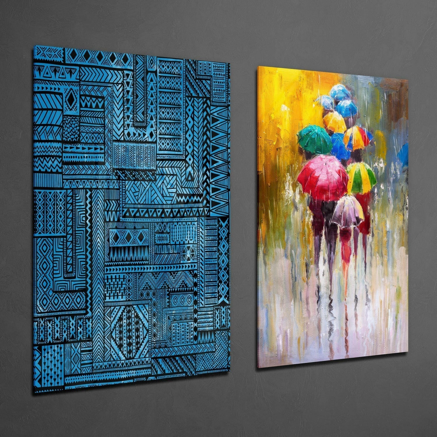 Two glass wall art panels displayed side-by-side: left panel features blue geometric patterns on black background; right panel shows colorful umbrellas in rain with yellow, red, and blue tones.