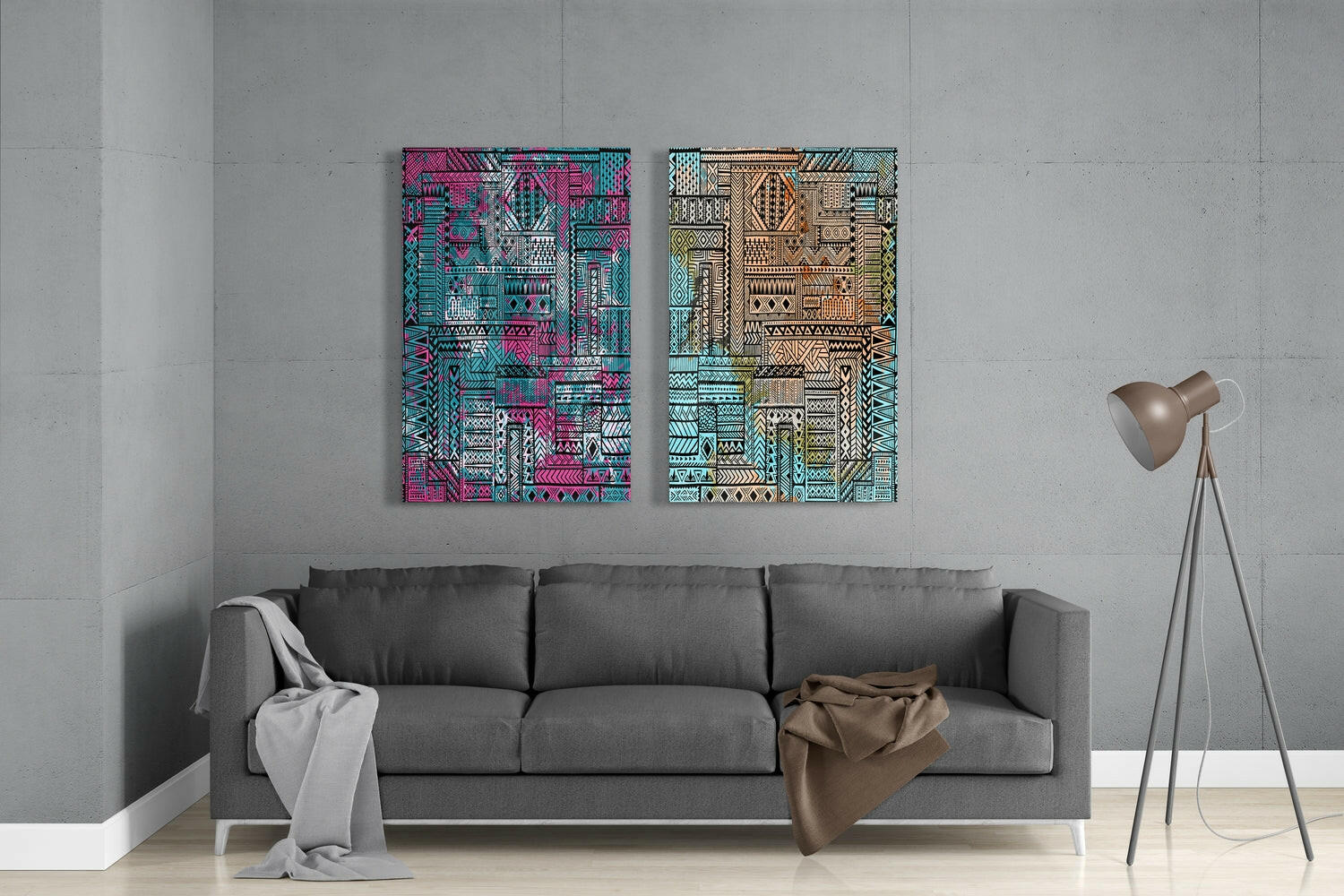 Two vibrant geometric glass panels in pink-turquoise and tan-green ethnic patterns hang above a gray sofa in a minimalist living room.