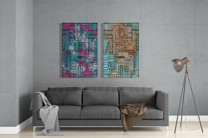 Two vibrant geometric glass panels in pink-turquoise and tan-green ethnic patterns hang above a gray sofa in a minimalist living room.