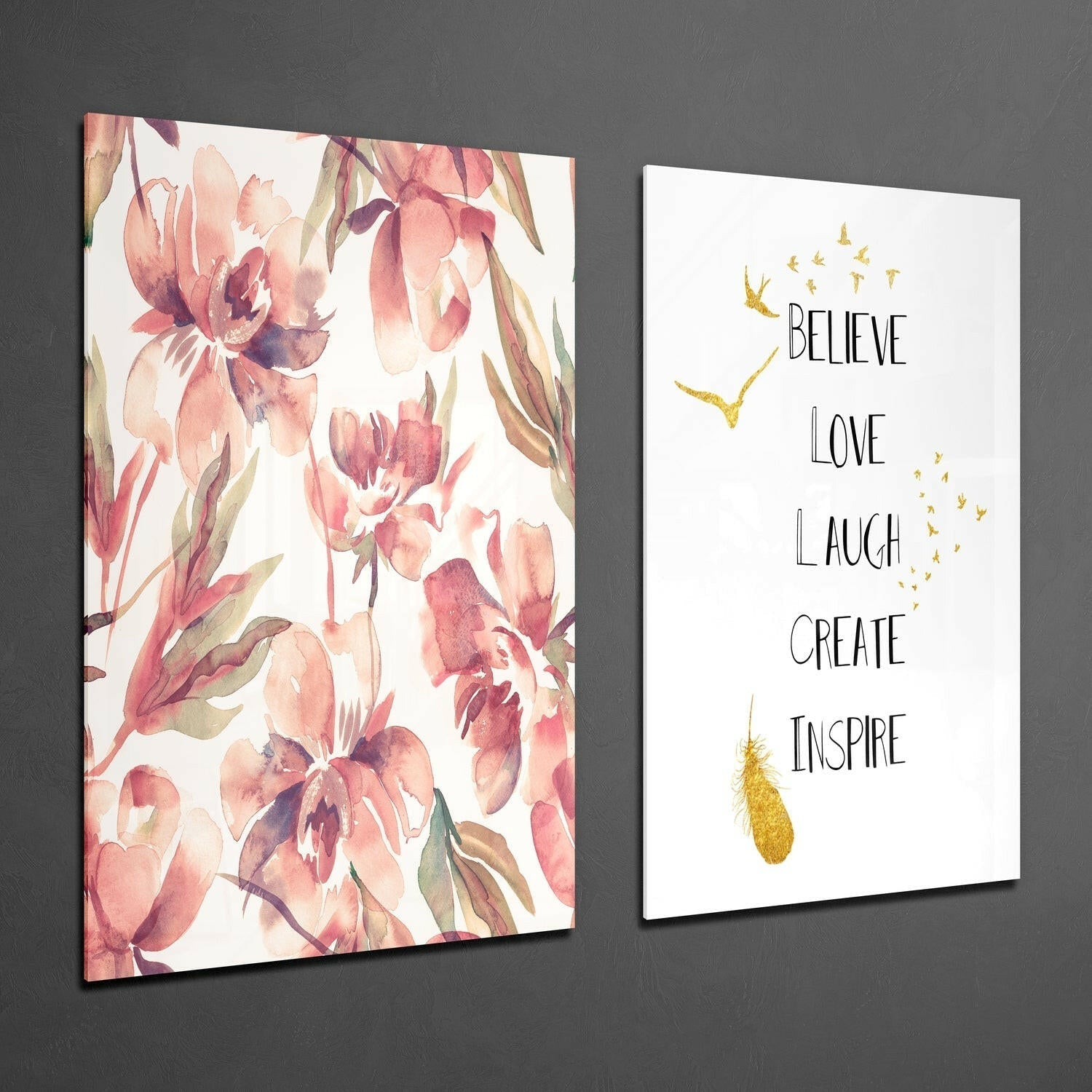Two framed glass wall art panels displayed at an angle against gray wall: left panel features pink watercolor flowers; right panel shows inspirational text with gold accents.