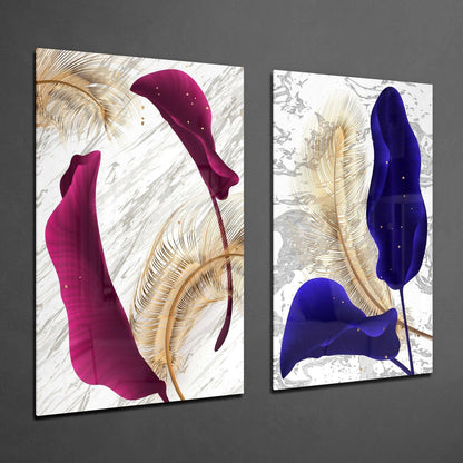 Two framed glass panels displayed at an angle showing magenta and blue abstract leaf shapes with gold feather details on marble textured backgrounds.