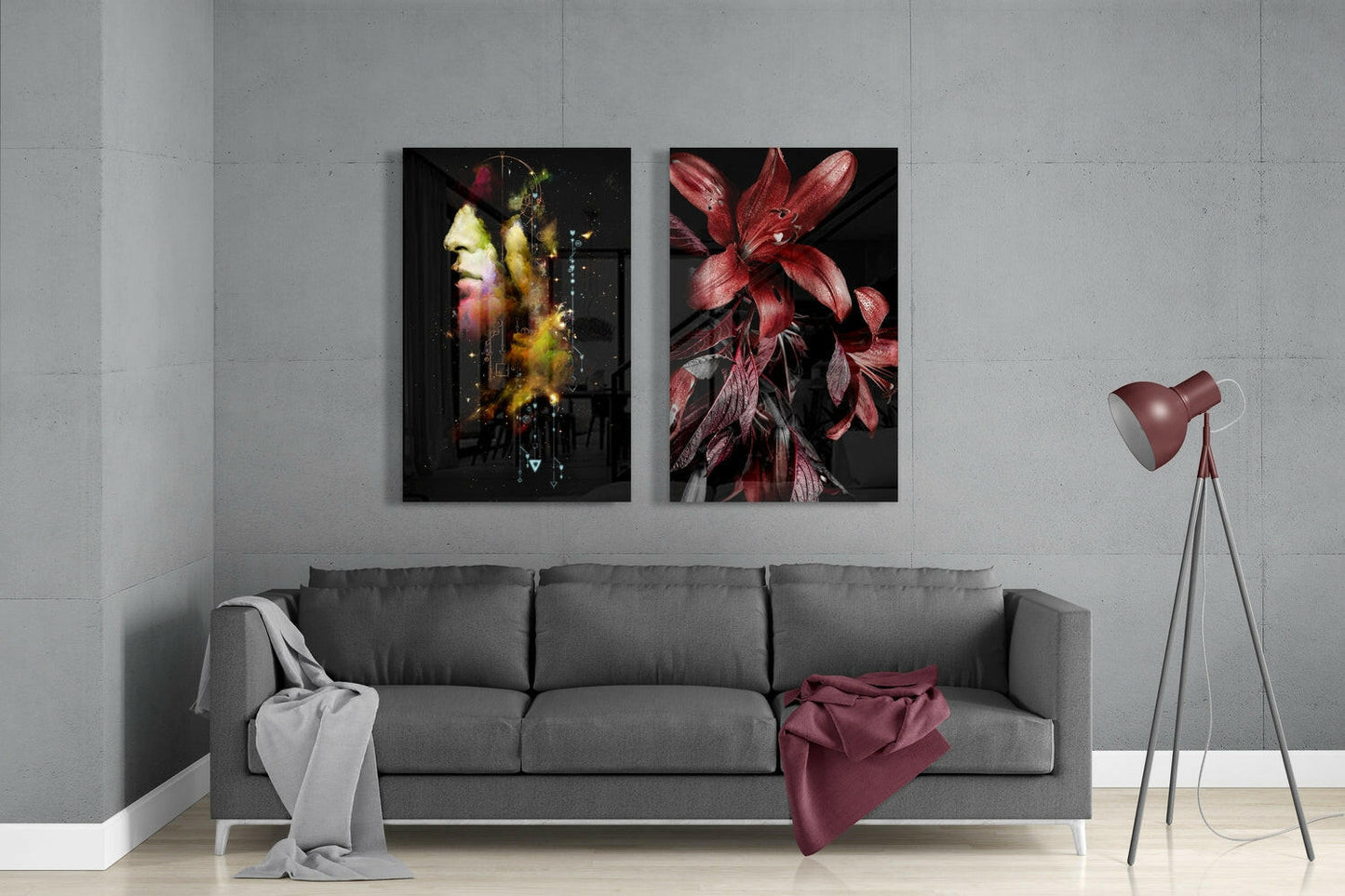 Modern living room with gray sofa displaying two framed glass artworks: portrait with warm tones on left, red flower on right.