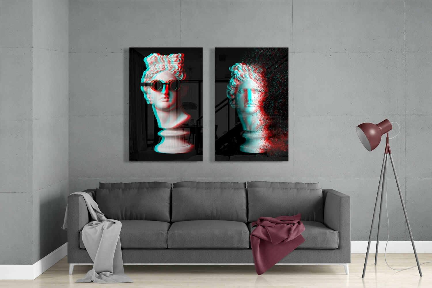 Modern living room with gray sofa displaying two framed glass wall artworks featuring cyan and red glitch-effect classical busts above.