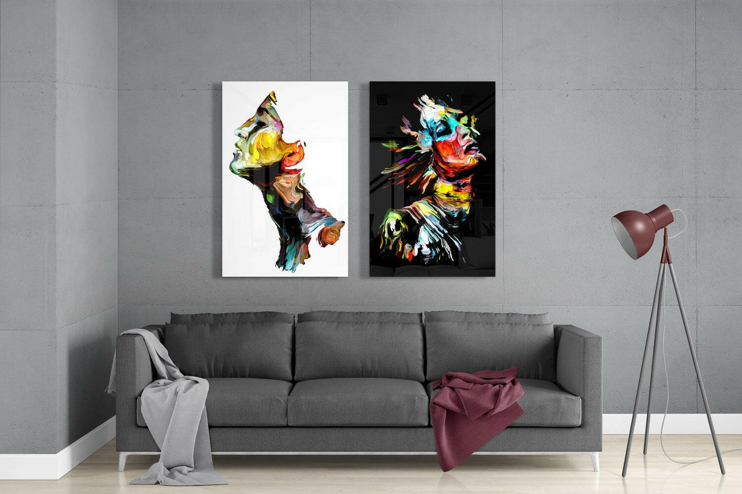 Two colorful abstract glass artworks displayed above a gray sofa in a modern living room setting.