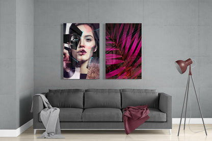 Two glass wall art panels hung above gray sofa: left panel shows abstract portrait with geometric overlays in pink and black tones; right panel displays magenta tropical plant leaves.