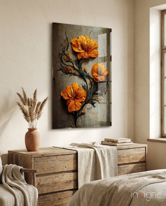 Orange glass flowers on dark branch displayed above wooden nightstand in minimalist bedroom with beige bedding and terracotta vase.