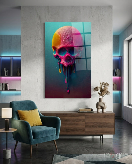 Colorful neon skull glass art with gradient pink and yellow tones displayed on concrete wall above wooden dresser in modern interior.
