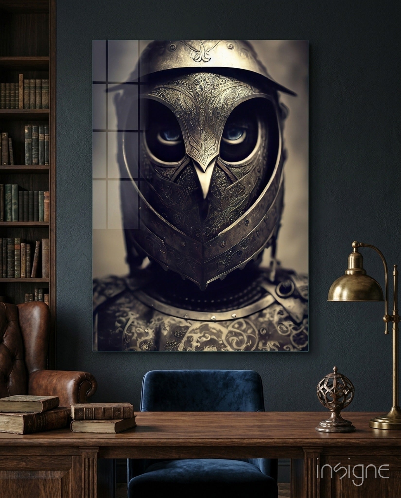 Ornate owl-headed knight helmet with intricate metalwork displayed on dark teal wall above wooden desk with brass lamp and leather chair.