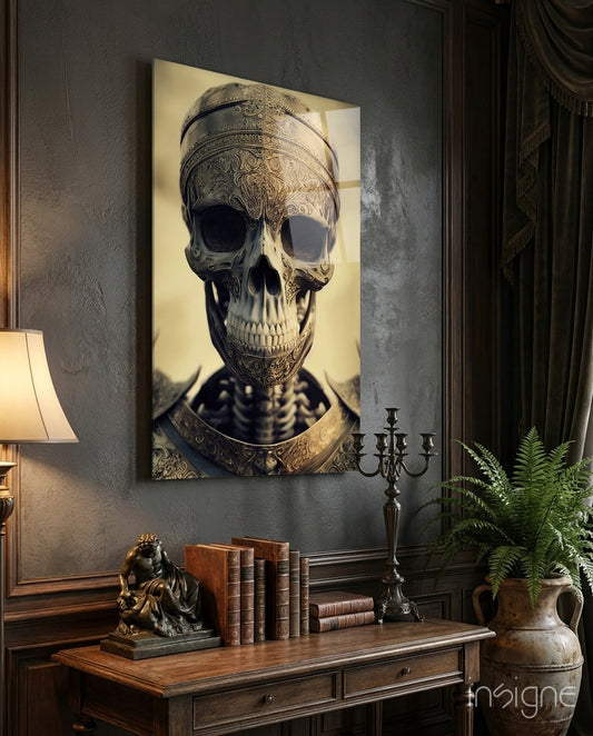 Ornate skull artwork with gold filigree detailing and cream background displayed above wooden desk with books and candelabra.