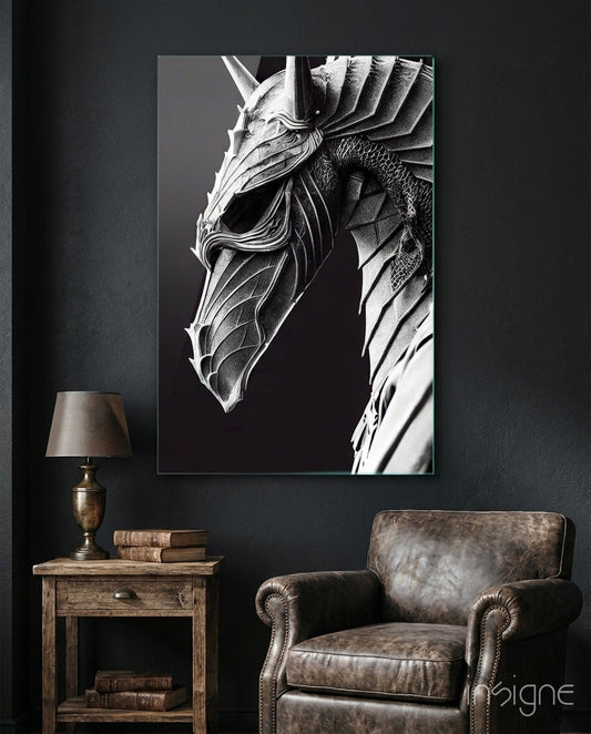 Monochromatic glass art depicting a detailed dragon head in profile against black background, displayed above leather armchair in dark interior setting.