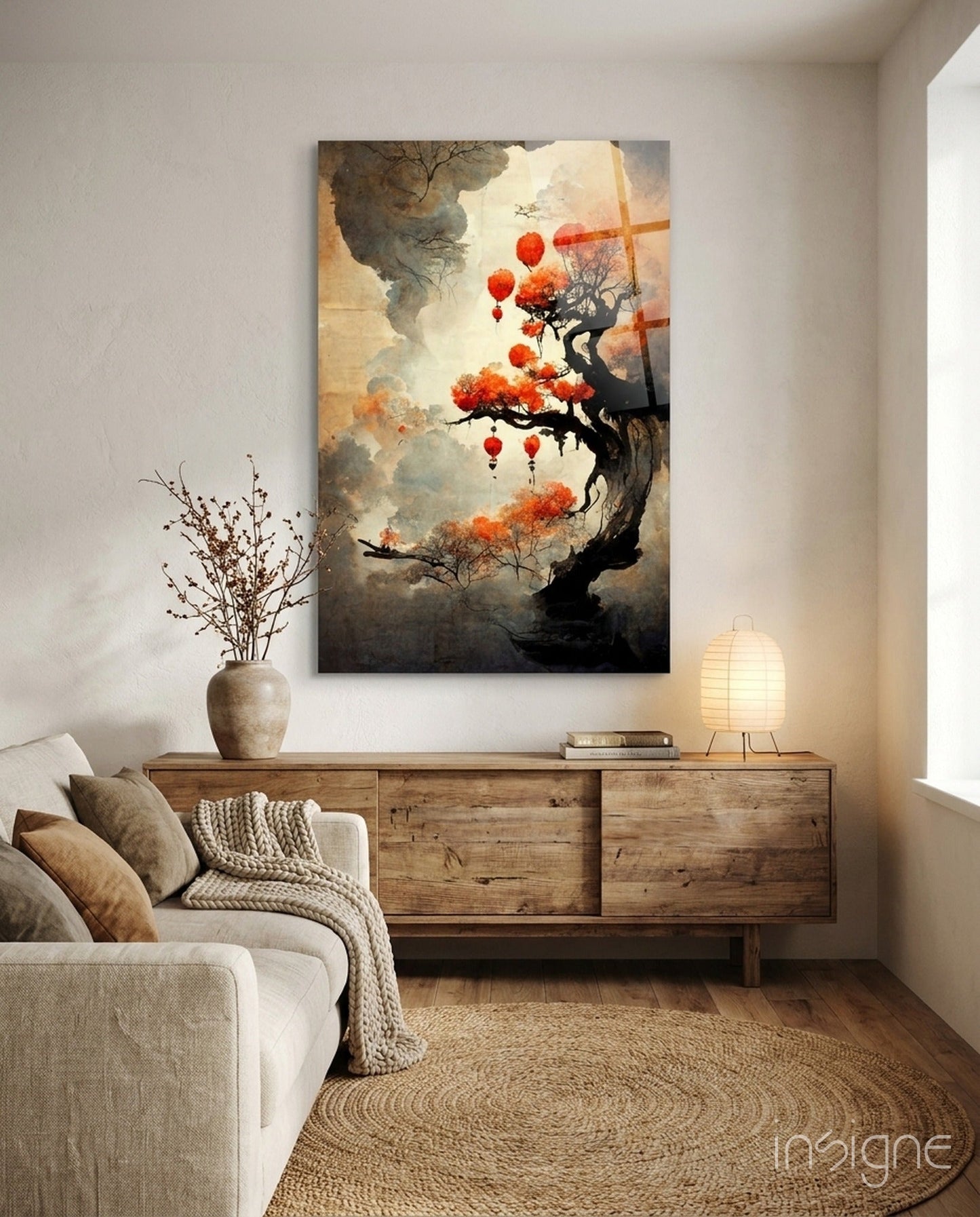 Glass art print hanging above wooden dresser in warm-toned living room with beige sofa and natural décor.