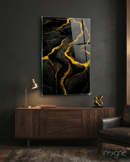Black and gold marbled slit glass art panel mounted above a wooden credenza in a modern interior setting.