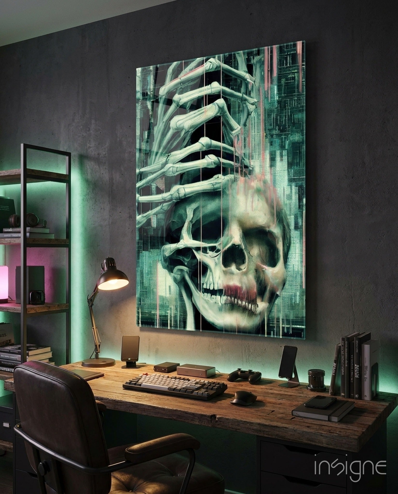 Glass art panel mounted above wooden desk displaying skeletal hands emerging from skull with green and pink architectural background in modern office setting.