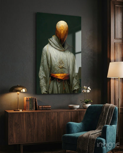 Headless Monk glass art with golden head and sage robes displayed above wooden dresser in contemporary interior setting.