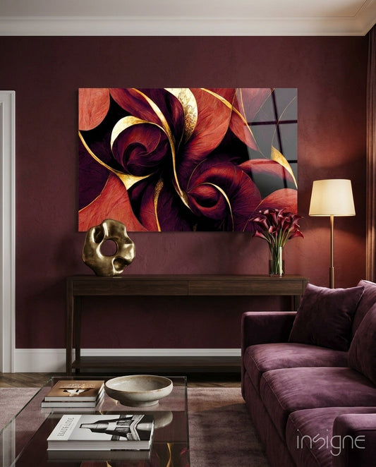 Crimson Petal Swirls Gold Ribbon glass wall art displayed above a dark wood console in a burgundy-walled living room with furnishings.