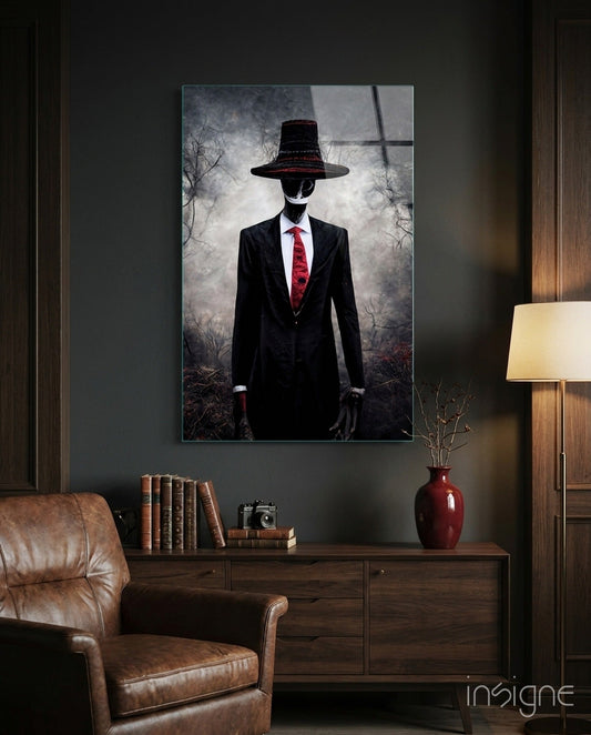 Glass art print displayed above wooden cabinet showing silhouetted figure in black suit and red tie wearing wide-brimmed hat against stormy background.