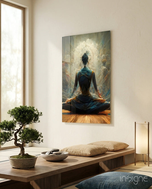 Glass wall art depicting a figure in lotus pose facing a glowing white mandala, displayed above a wooden bench in a minimalist meditation room.