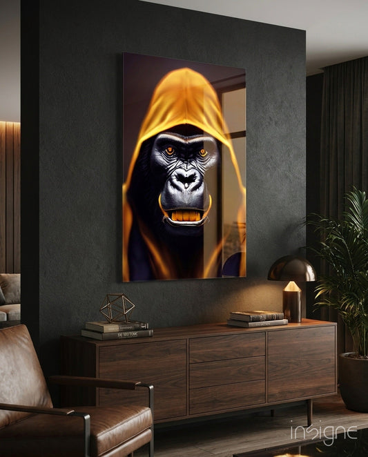 Glowing amber hood gorilla portrait glass art displayed on dark wall above wooden dresser in modern living room interior.