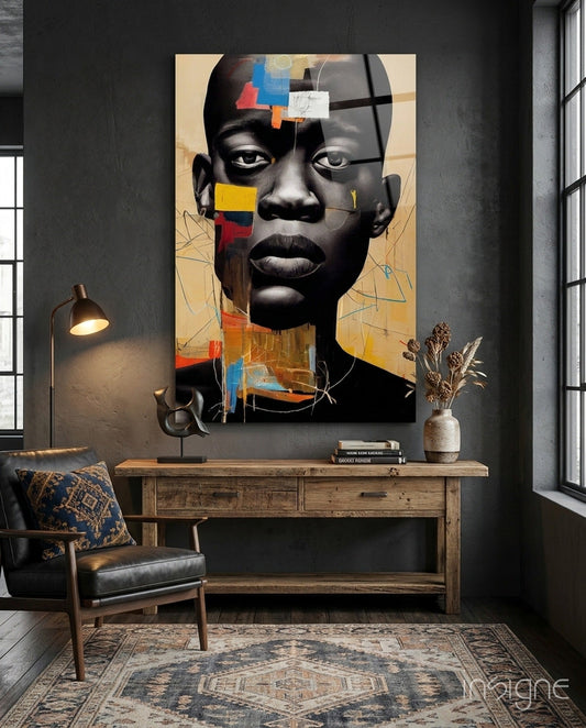 Modern interior space featuring abstract portrait glass art with black face, colorful geometric shapes, and tan background displayed above wooden console table.