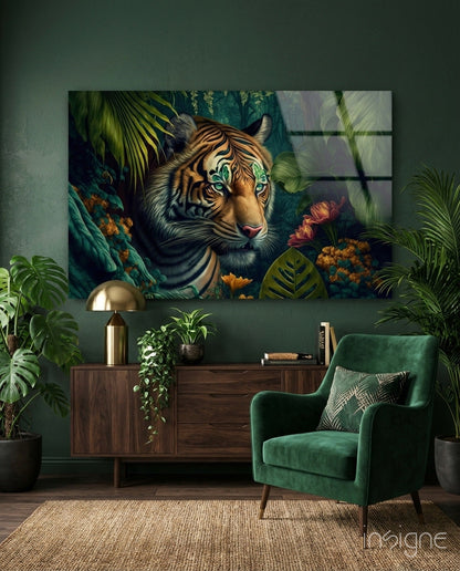 Tiger with striking green eyes surrounded by tropical foliage and flowers displayed as glass wall art above wooden furniture in green interior.