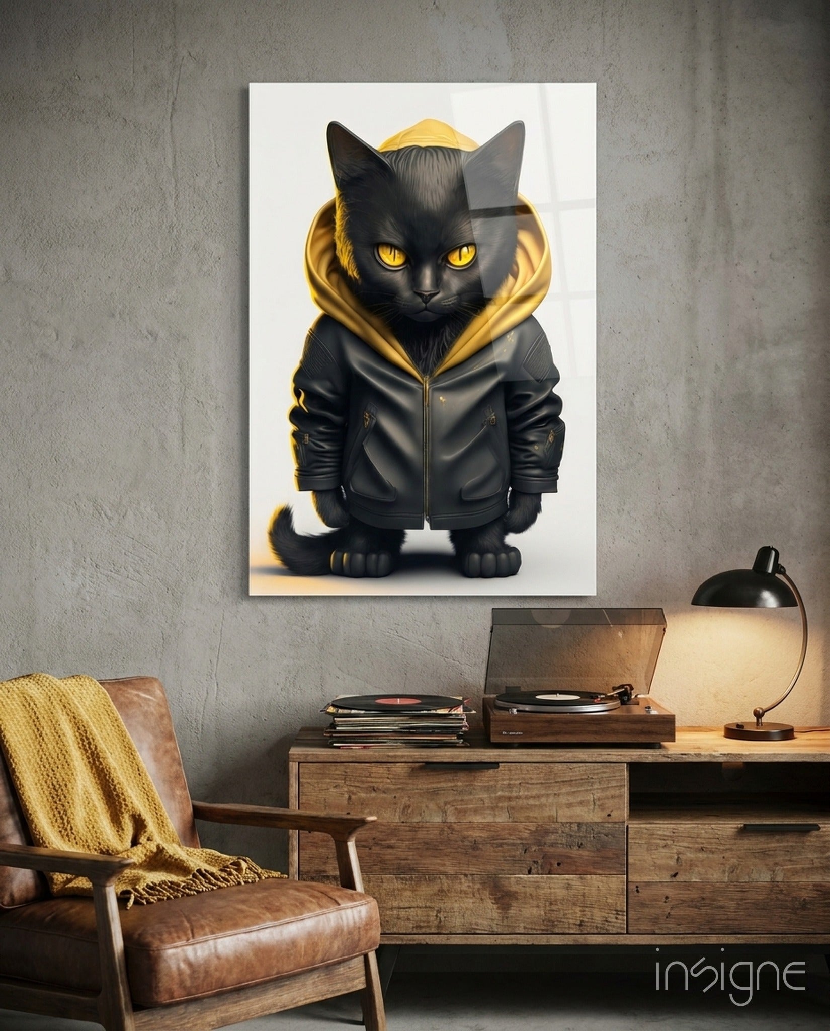 Black cat wearing gold-trimmed black jacket displayed on white wall above wooden desk with lamp and vinyl records.