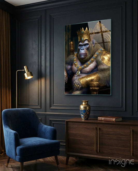Regal gorilla in gold crown and armor displayed on dark paneled wall above wooden cabinet in modern interior setting.