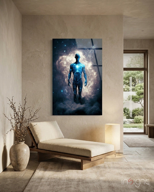 Glass wall art depicting a glowing blue humanoid figure standing against a cosmic cloud background, displayed in a minimalist interior space above a wooden daybed.