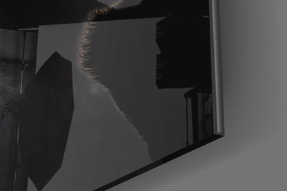 Backlit silhouette of three monkey profiles etched in frosted glass panel mounted on white wall.